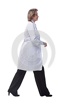 Side view of busy medical doctor woman going sideways