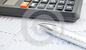 Side view calculator and pen, financial accounting and analysis, business concept