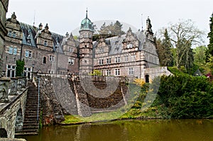 Side view on the castle Emmerthal from the garden with a lake