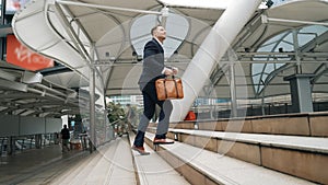 Side view of caucasian businessman walking up stairs. Finding a job. Urbane.