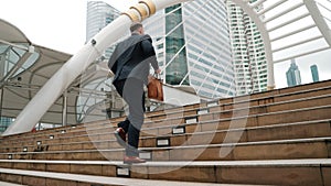 Side view of caucasian businessman walking up stairs. Finding a job. Urbane.