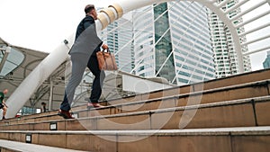 Side view of caucasian businessman walking up stairs. Finding a job. Urbane.