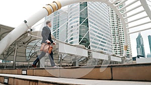 Side view of caucasian businessman walking up stairs. Finding a job. Urbane.