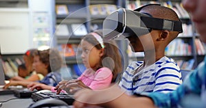 Side view of Caucasian schoolboy using virtual reality headset in the classroom 4k