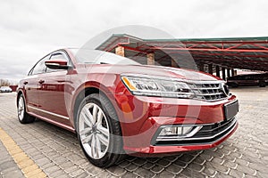 Side view of cherry red business sedan car