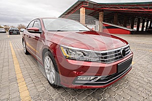 Side view of cherry red business sedan car