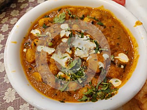 Side view Chola Chana Chaat, Bowl of Chickpeas curry or Chola masala. Ramadan Iftari Dinner. Ramzan Meal.