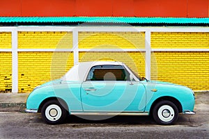 Side view of classic car parked on street in city