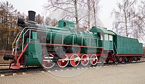 Side view of classic old green steam locomotive