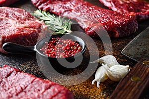 Side view Close up on red pepper near machete Steak, Flank steak, cut near denver alternative beef steak and a cleaver butcher