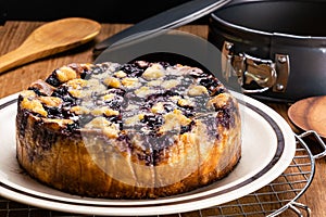 Side view closeup of freshly baked delicious homemade blueberry and crumble cheesecake