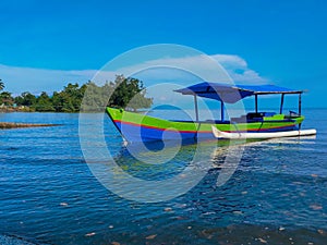 Colorful outrigger boat with a tranquil scene on Morowali beach