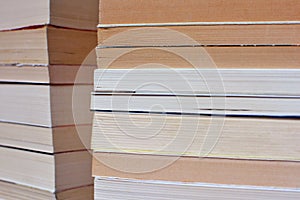 Side view of corner of multiple old stacked books