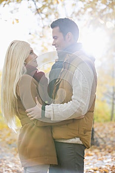 Side view of couple hugging in park