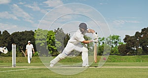 Side view of cricket player shooting in the ball