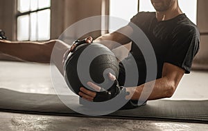 Man doing abs exercise with medicine ball