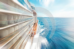 Side view of cruise ship on the blue sky background with copy space, blue tone with motion blur effect