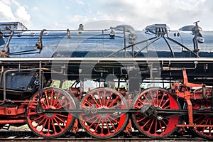 Side view on CSD, Czechoslovak steam locomotive, with huge, red spoke main wheels