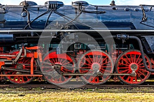 Side view on CSD, Czechoslovak steam locomotive, with huge, red spoke main wheels