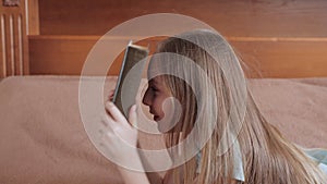 Side view of cute girl banging head with book