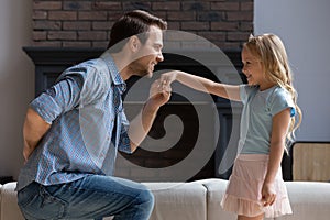 Father making curtsey took hand of daughter for a kiss photo