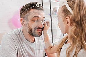 side view of daughter doing makeup