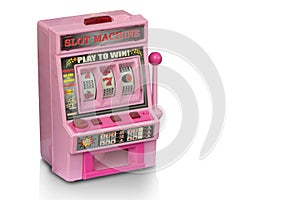 Side view dicut pink old toy slot machine on white background,copy space