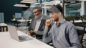 Side view diverse happy colleagues men african businessman talking with arabian employee worker having fun together