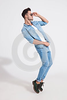 Side view of a dramatic casual man dancing