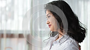 Side view dreaming Asian businesswoman smiling and having good time enjoying break