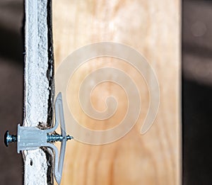 Side view of a drywall mount anchor and screw