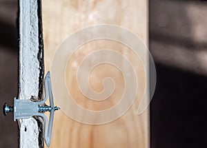 Side view of a drywall mount anchor and screw