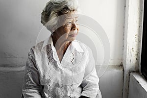 Side view of elderly asian woman with thoughtful face expression