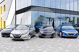 Side view of electric cars hood standing beside new cars for sell outdoors. Choosing and buying new car concept