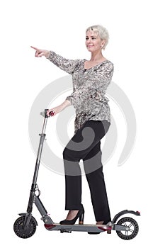 side view. elegant young woman with an electric scooter looking at you .