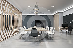 Side view of empty coworking office interior with meeting table and chairs, decorative partition, concrete floor and dark