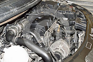 Side view of the engine compartment of a car with a three-cylinder diesel engine