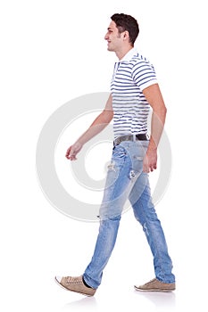 Side view of a fashion man walking forward