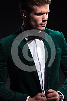 Side view of a fashion model in green velvet suit