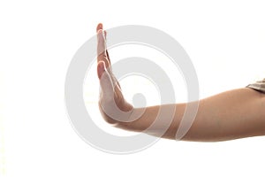 Side view of female hand showing stop gesture, isolated on white background