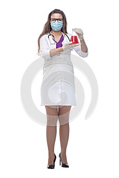 Side view. a female medic in a protective mask holds a laboratory flask