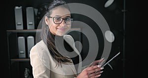 Side view of female office worker using electronic device