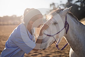 side view of female vet stroking horse