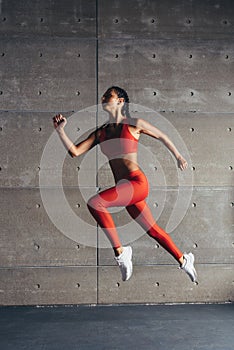 Side view fit woman doing cardio training.