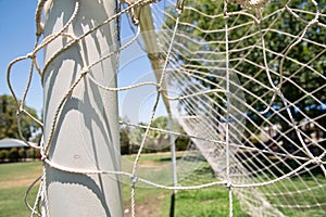 Side-view of a football goal with netting on a soccer pitch