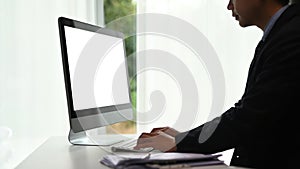 Side view of a freelance graphic designer man is working on computer at his workspace.