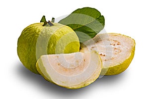 Side view of fresh guava fruit whole and half with green guava leaf