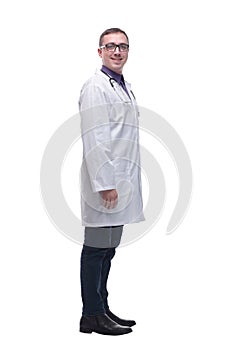 Side view full length confident male medical doctor in uniform looking at camera