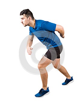 Side view full length of determined caucasian man runner standing in running position looking ahead confident. Young guy sprinter