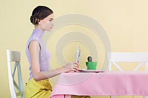 side view of girl eating cactus with fork and knife diet